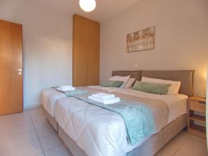 a bedroom with a large bed with towels on it at Peris #2 - Souda in Souda