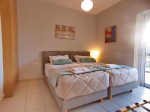 a bedroom with a large bed with two pillows at Peris #2 - Souda in Souda
