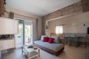 a living room with a couch and a table at Stergios top view residence with jacuzzi in Kolymbia