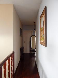 a hallway with a staircase with a mirror on the wall at Casa da Kau in Ouro Preto +56 photos
