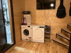 a laundry room with a washer and dryer at Cottage SUNNY in Itʼkhvisi +3 photos