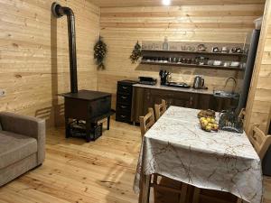a kitchen with a table and a stove in a room at Cottage SUNNY in Itʼkhvisi