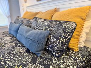 a pile of pillows sitting on a couch at The Landgrove in North Landgrove +25 photos