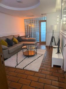 a living room with a couch and a table at Elegant Getaway - Spacious 3 Bedroom Apartment -Lisbon Baixa da Banheira in Lavradio