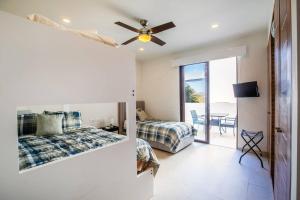 a bedroom with a bed and a ceiling fan at Alamar Vallarta in Cruz de Huanacaxtle +59 photos