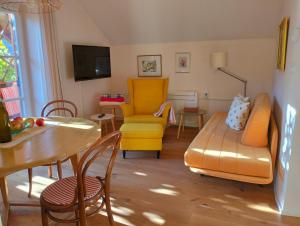 a living room with a couch and a table and chairs at Haus Tinkhauser in Vilpiano