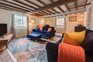 a living room with two blue couches and a tv at 4 Bed in Westleton oc-holc in Westleton