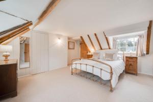 a white bedroom with a bed and a window at 4 Bed in Westleton oc-holc in Westleton