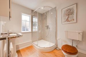a bathroom with a shower and a toilet at 4 Bed in Westleton oc-holc in Westleton +10 photos