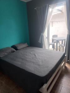 a bedroom with a bed and a window and a table at Paramecó in Balneario Claromecó +7 photos