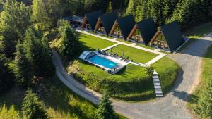 an aerial view of a house with a swimming pool at A Frames By Pensiunea Merișor in Răchiţele