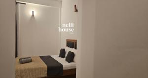 a bedroom with a bed in a white room at nelli house in Galle