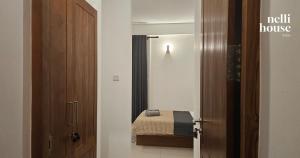 a room with a bedroom with a bed and a door at nelli house in Galle