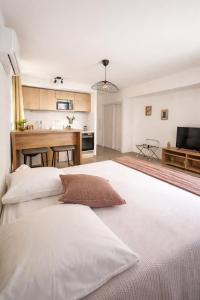 a large white bed in a room with a kitchen at SOUS LES PLATANES in Velaux +32 photos