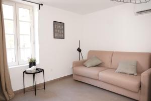 a living room with a couch and a window at SOUS LES PLATANES in Velaux