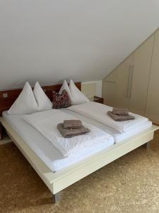 a large white bed with two towels on it at Ferienwohnung Jehsner in Gries
