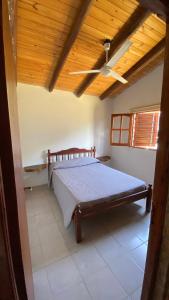 a bedroom with a bed with a wooden ceiling at La Empinada in Bialet Massé