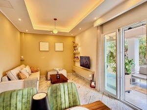 a living room with a couch and a table at Villa Sunlight Sidari with private pool by DadoVillas in Sidari