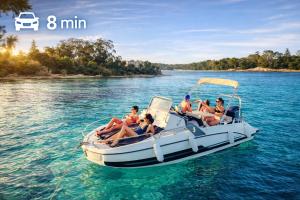 a group of people sitting on a boat in the water at Beachfront Villa Cannes I Garden - Terrace & Sea View -Prime Location- Free Parking in Cannes