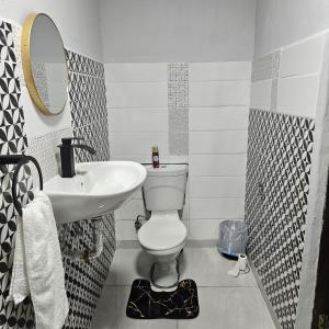 a bathroom with a white toilet and a sink at 14 Isabel Room 2 in Centurion +11 photos
