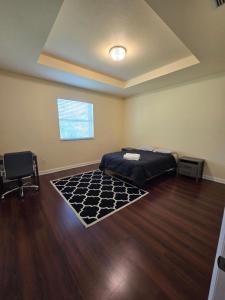 a room with a bed and a chair in it at Atlas in Homestead