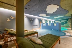 a childrens play room with a swimming pool and a play floor at Hotel Zauchensee Zentral in Zauchensee