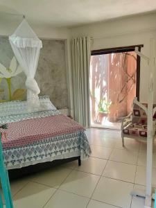 a bedroom with a bed and a window at Cozy Suite Olinda in Olinda