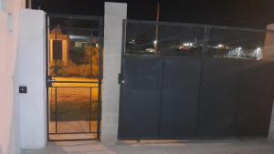 an open door of a building with a fence at La Goldie in Concepción del Uruguay