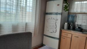 a kitchen with a refrigerator next to a window at La Goldie in Concepción del Uruguay
