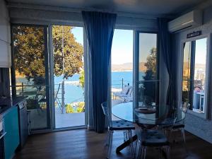 a kitchen with a table and a view of the water at The sea-cave house in Puerto de Mazarrón