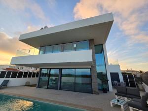 a house with a pool in front of it at Sunrise Villa in Sagres