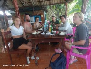 a group of people sitting around a table at Hostal La Gloria in Mérida