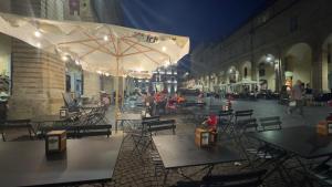 an empty patio with tables and umbrellas on a street at Tre Archi Sea Home in Lido di Fermo