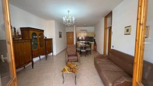 a living room with a couch and a dining room at Tre Archi Sea Home in Lido di Fermo