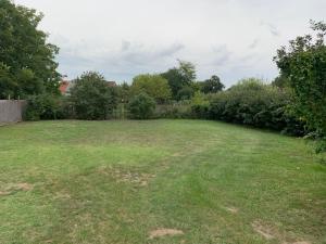 a yard with a large field of green grass at Beni Apartman in Balatonlelle +2 photos