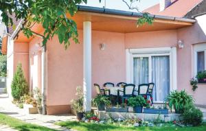 a group of chairs sitting on the porch of a house at Beni Apartman in Balatonlelle