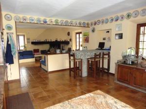a kitchen and living room with a table and chairs at Villa Vallevento in Calamandrana