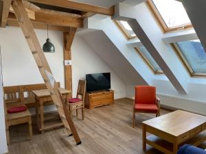 a living room with a table and a tv at Reitterhof in Laufnitzdorf in Frohnleiten
