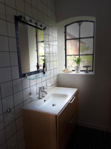 a bathroom with a sink and a mirror at Fårhuset at Åkarp in Trelleborg