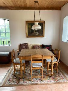 a dining room with a wooden table and chairs at Fårhuset at Åkarp in Trelleborg +22 photos