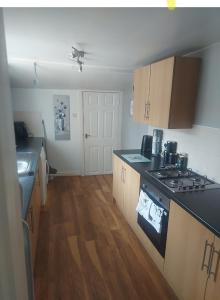 a kitchen with a stove and a counter top at 3 Bedroom Apartment near the Beach in South Shields
