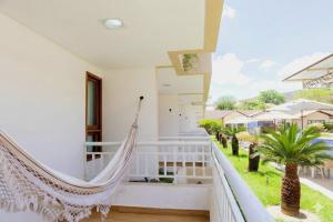 a hammock on the balcony of a house at Porto da Serra Hotel in Gravatá