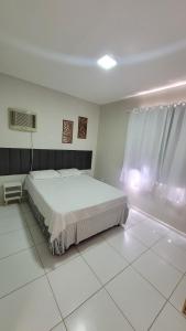 a bedroom with a large bed in a white room at Apartamento no Cond Vinhedos in Petrolina +30 photos