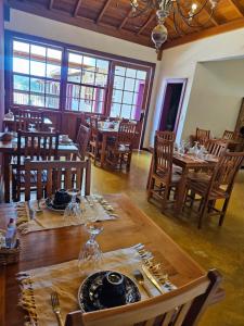a dining room with wooden tables and chairs at Pousada Berço Mineiro in Tiradentes +106 photos