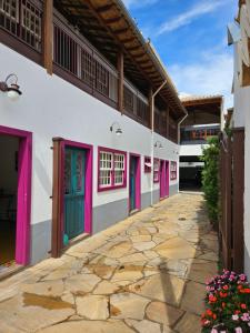 a courtyard of a building with colorful doors at Pousada Berço Mineiro in Tiradentes