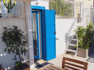 an open blue door on a house with stairs at Vico Lungo 9, Peschici in Peschici
