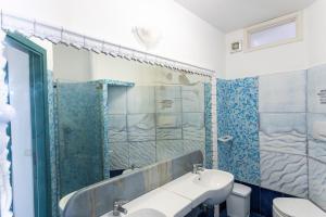 a bathroom with a sink and a shower at Appartamenti Castello in Peschici +18 photos