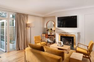 a living room with a couch and a fireplace at Rufflets St Andrews in St. Andrews