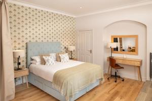 a bedroom with a bed and a desk and a chair at Rufflets St Andrews in St. Andrews