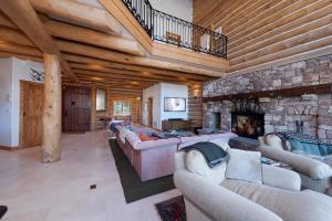 a large living room with couches and a stone fireplace at 526 Alan Rd - Durango CO. in Durango